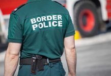Person in Border Police uniform standing outdoors.