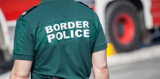 Person in Border Police uniform standing outdoors.