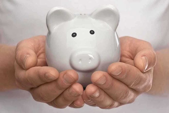 shutterstock_98671160.jpg Hands holding a white ceramic piggy bank