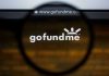 Magnifying glass over GoFundMe website logo.