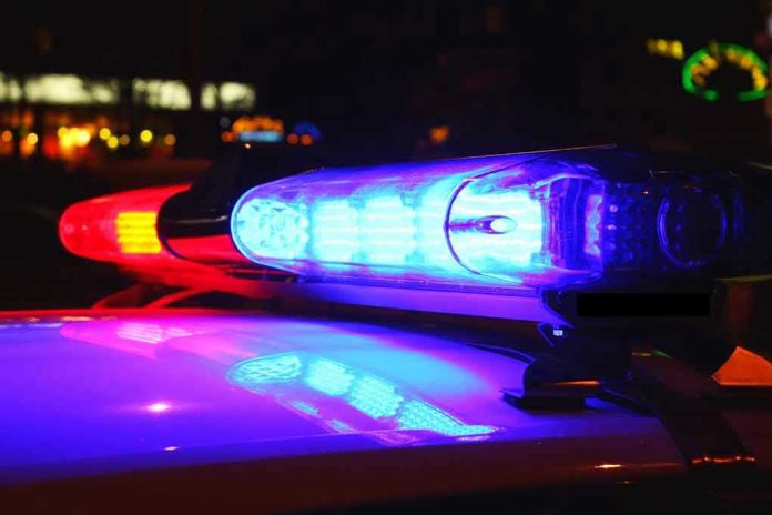 185887181 Police car lights flashing red and blue.