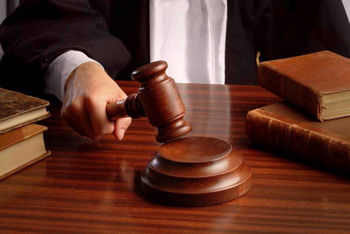 2080475 Judges gavel on desk with books.