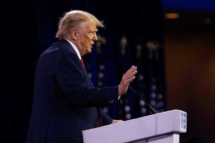 Person speaking at a podium with hand raised