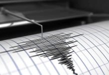 Seismograph needle recording earthquake activity on paper.