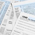 Tax forms and documents overlapping on surface