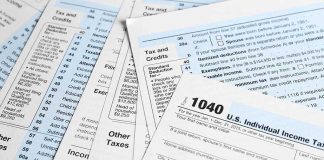 Tax forms and documents overlapping on surface