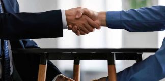 Handshake and exchange of money under the table.