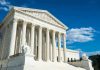 Marijuana Users and Guns: SCOTUS Decision Looms! Building with columns under a blue sky.