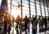 Airport Massacre Foiled – Cops ARREST Shooter Crowd of travelers in airport terminal with airplane outside.