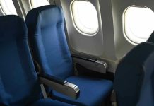 Emergency LANDING: In-Flight STABBING, Passengers Attacked! Empty airplane seats next to windows.