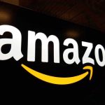 Amazon SLASHES 14,000 Jobs — AI Takeover Begins Amazon logo with a yellow smile arrow.
