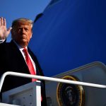 Trump Pardons Felon – Sets Congress Off! A political figure waving while standing on the steps of an aircraft