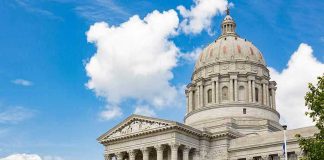 Large white government building with a dome.