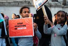 Hospital Massacre Stuns—World Watches Helpless Children holding signs at a protest against Darfur genocide.