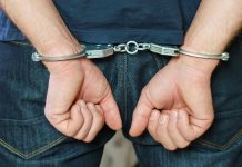 Mob INFILTRATES College Sports — Athletes BUSTED Person in handcuffs behind their back.