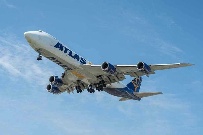Airplane with Atlas logo flying in the sky.