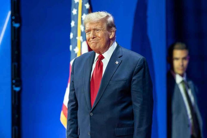 Man in suit next to American flag.