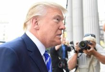 TRUMP DEMANDS Senate Rule TORCHED—Government Chaos Erupts Man in suit with photographers in background.