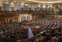 No Work, No Pay – Congressional Checks FROZEN! Large assembly in a government legislative chamber.