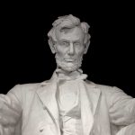Marble statue of Abraham Lincoln seated with a serious expression