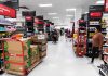 Interior of a grocery store with shelves filled with products and shoppers