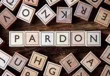 Trump Pardons Political Allies — Legal Chaos Follows Wooden letter blocks arranged to spell 'PARDON' on a wooden surface