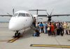 Passengers boarding a small aircraft at an airport