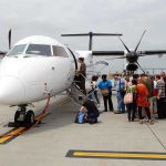 Passengers boarding a small aircraft at an airport