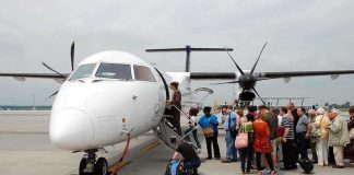 Passengers boarding a small aircraft at an airport