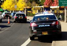 Mother’s Campaign Solves HORRIFYING School Murder Police cars and school buses on a road.