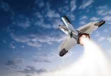 SpaceX’s SECRET Military Mission Rocket launching into the sky with clouds.