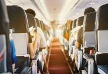 Mid-Flight Nightmare SHOCKS Passengers Passengers seated inside an airplane cabin.