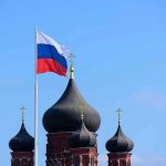 Cyber War on Democracy: Russia’s New Tactics Russian flag next to church domes.