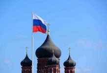 Cyber War on Democracy: Russia’s New Tactics Russian flag next to church domes.