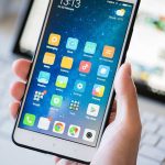 WhatsApp’s Own System Used Against It! A person holding a smartphone displaying various mobile applications