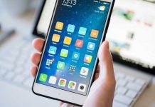 WhatsApp’s Own System Used Against It! A person holding a smartphone displaying various mobile applications