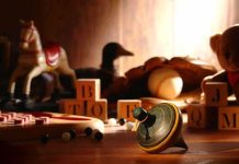 Stunning Shift: Toys Aren’t Just for Kids Anymore A wooden spinning top surrounded by vintage toys and colorful blocks