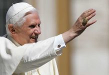 Pope Benedict XVI smiling and waving during a public appearance