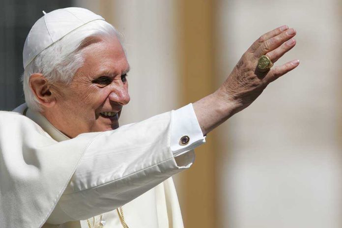 Pope Benedict XVI smiling and waving during a public appearance