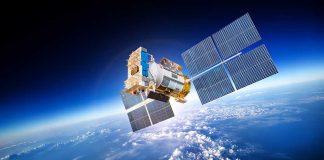 A satellite equipped with solar panels orbiting above the Earth