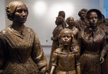 Bronze sculptures of women and children in historical attire