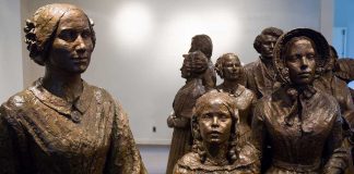 Bronze sculptures of women and children in historical attire