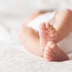 Historic Baby News SHAKES White House Close-up of baby feet lying on blanket.