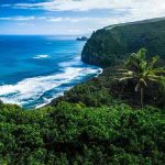 Outrage Erupts Over Hawaii’s Racist Gun Law Beautiful coastal landscape with lush greenery and ocean waves.