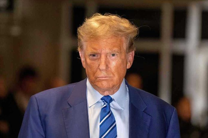 Man in blue suit and striped tie, serious expression.