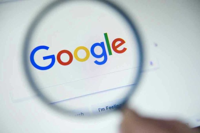 746561200 Google logo viewed through a magnifying glass.