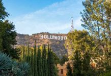 $110B Hollywood Mega-Merger Shocks All Hollywood sign on hill surrounded by trees and buildings.