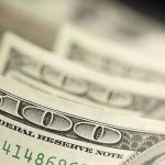 Visa Loophole Enables $2.7M Scam Close-up of hundred-dollar bills.