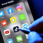 Predator App BLOCKS Police From Missing Teen Social media apps on phone screen with hand holding stylus.