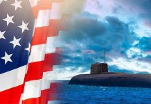 Navy SLAMMED Over Submarine Budget Blowout American flag and submarine at sea under a cloudy sky.